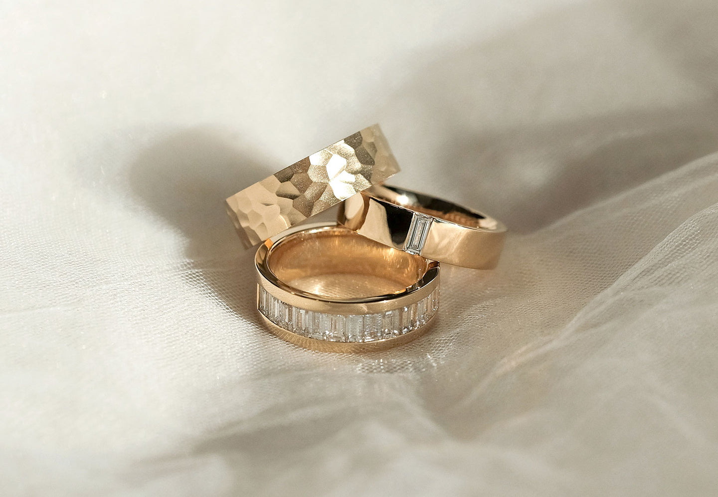 The Hammered, The Flush Baguette, and The Channel Baguette rings from Holden, all in yellow gold.