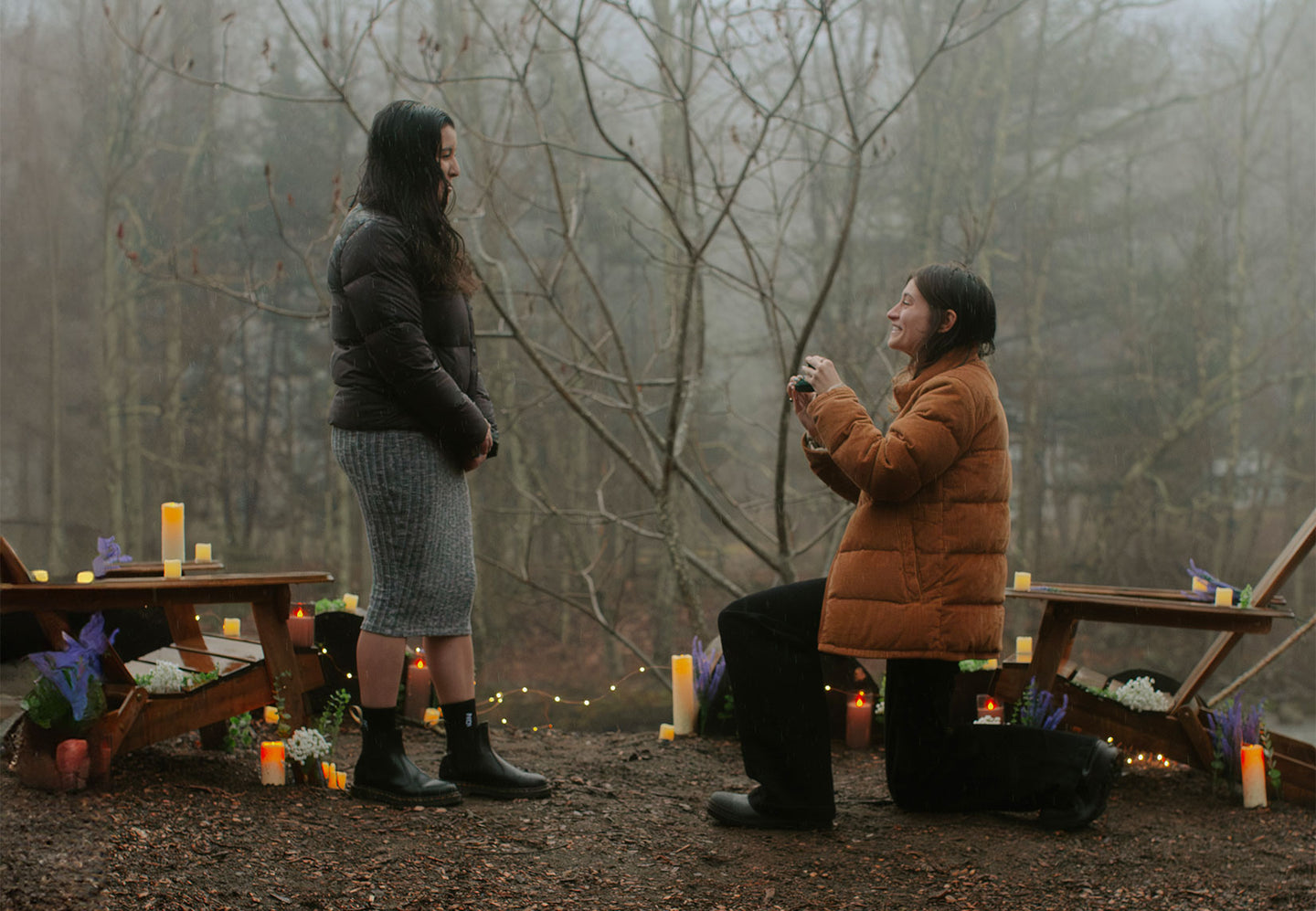 Partner gets down on one knee to propose to the other partner