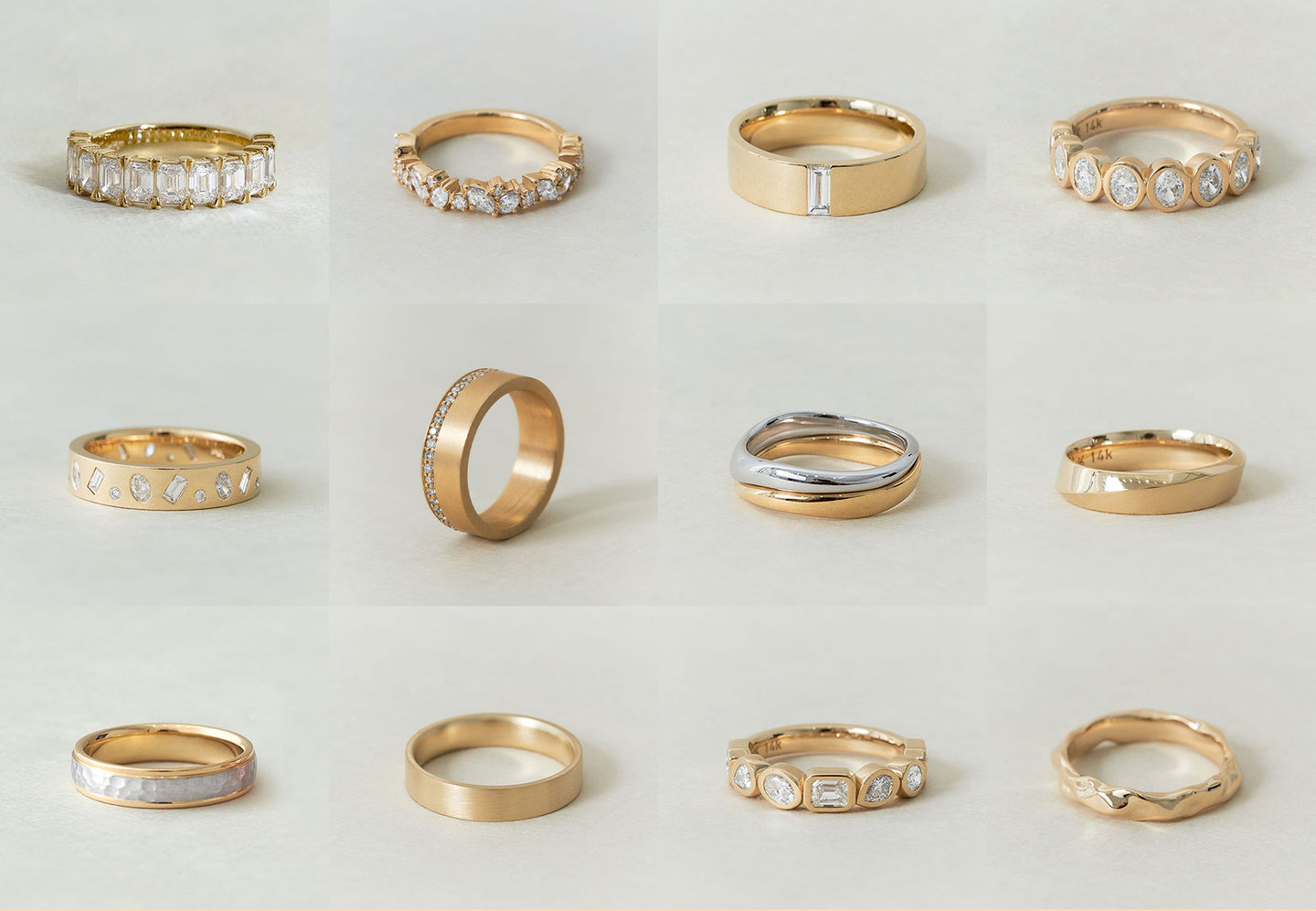 A grid of 12 solid gold and diamond and gold rings sit on a flat, neutral surface.